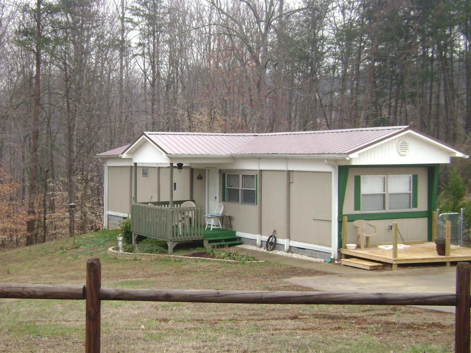 Mauve metal roof on a manufactured home with a new front deck in Pemberville